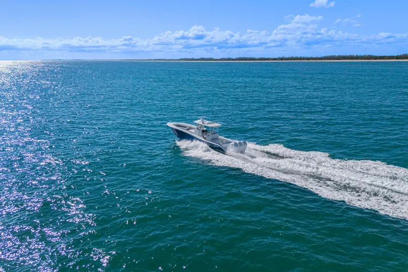 Slide: The Image of 2026 Yellowfin 36 Offshore boat cruising on open blue ocean under clear sky. - 6