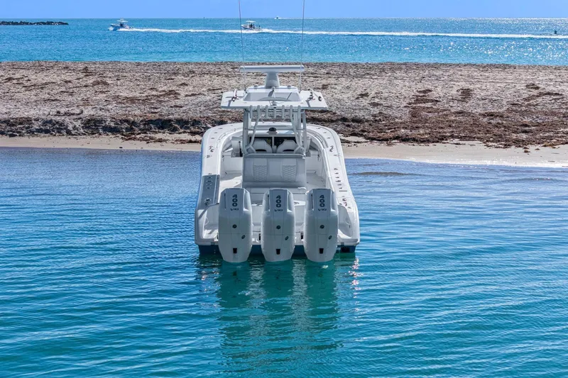 Slide: The Image of 2026 Yellowfin 36 Offshore boat with quad engines near sandy beach. - 61