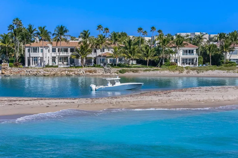 Slide: The Image of 2026 Yellowfin 36 Offshore boat near luxury waterfront homes and palm trees. - 63