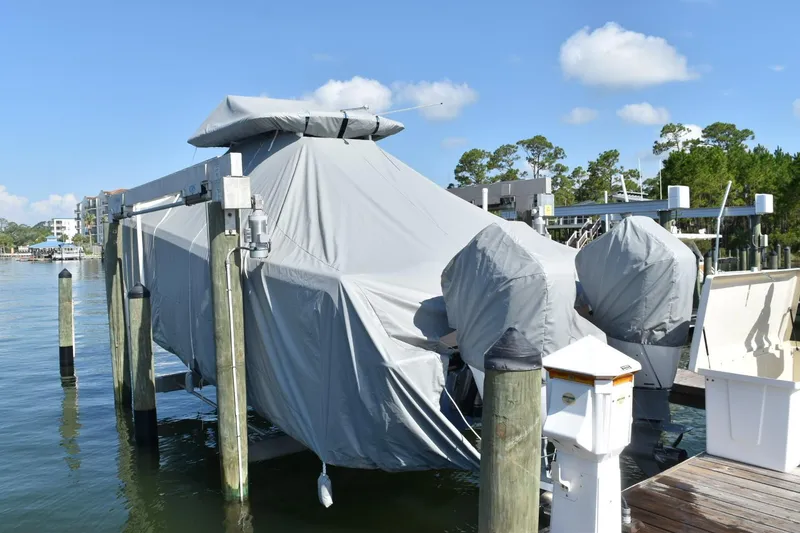 Slide: The Image of Covered 2025 Caymas 34 CT boat on a lift at a marina dock. - 13