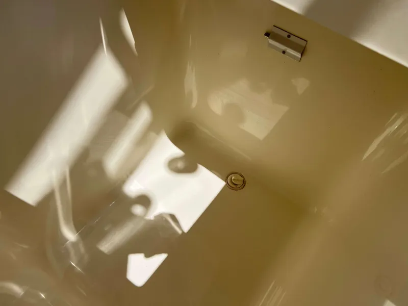 Slide: The Image of Interior view of a 2022 Henriques 42 Express Hardtop boat, showcasing a clean, reflective surface. - 10