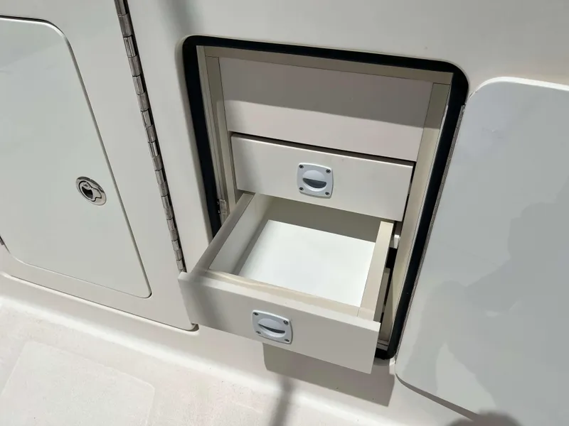 Slide: The Image of Open storage drawer on 2022 Henriques 42 Express Hardtop boat, showcasing interior compartments. - 12