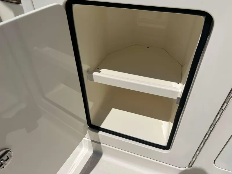 Slide: The Image of Open storage compartment on 2022 Henriques 42 Express Hardtop boat. - 14