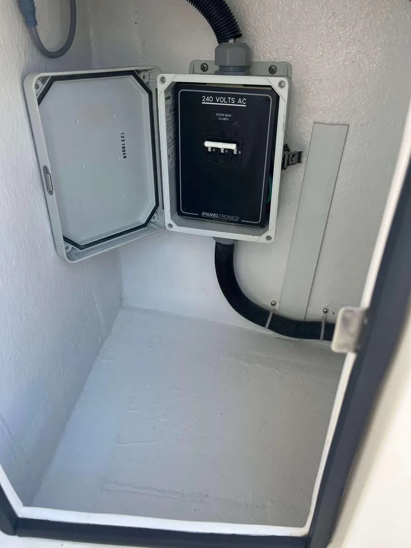 Slide: The Image of Electrical panel inside 2022 Henriques 42 Express Hardtop boat, featuring 240 volts AC. - 16