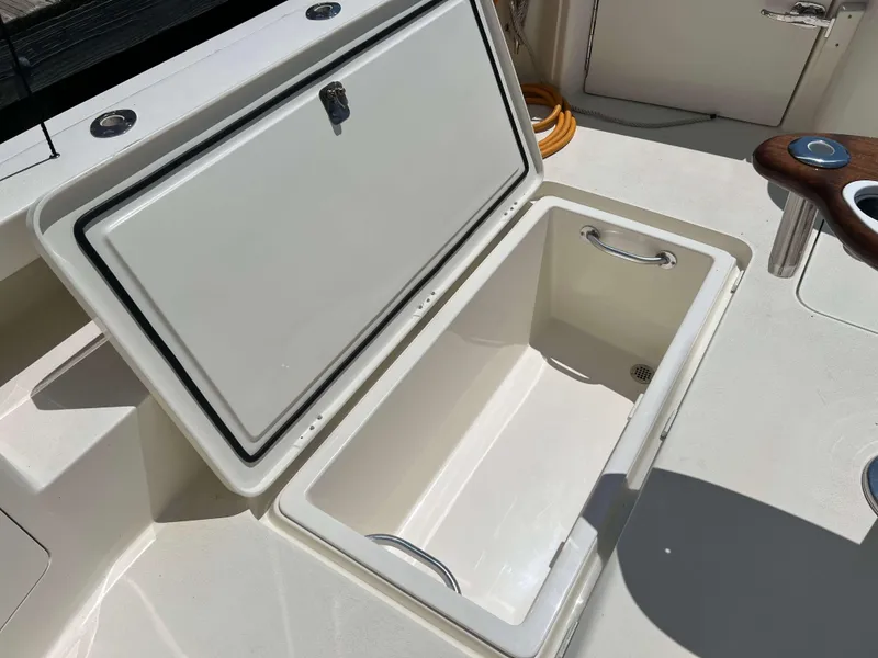 Slide: The Image of Open storage compartment on 2022 Henriques 42 Express Hardtop boat deck. - 18