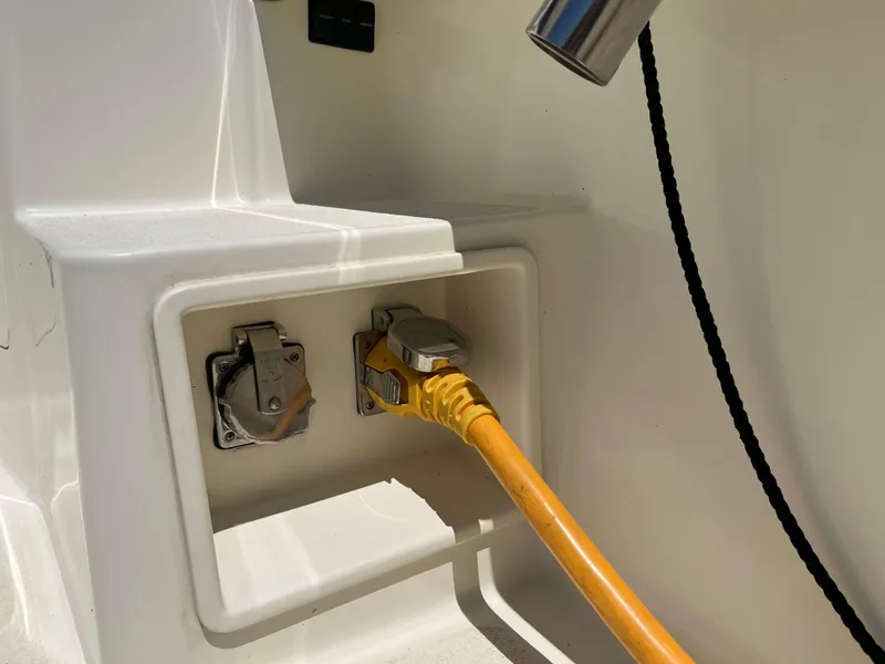 Slide: The Image of Power connection on 2022 Henriques 42 Express Hardtop boat, featuring yellow cable and outlet. - 19