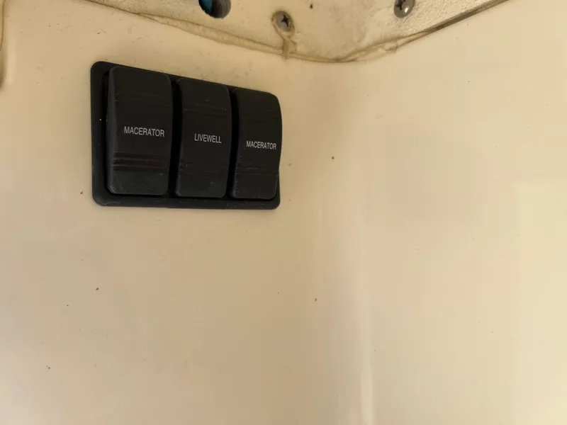 Slide: The Image of Switch panel on 2022 Henriques 42 Express Hardtop boat, featuring macerator and livewell controls. - 20