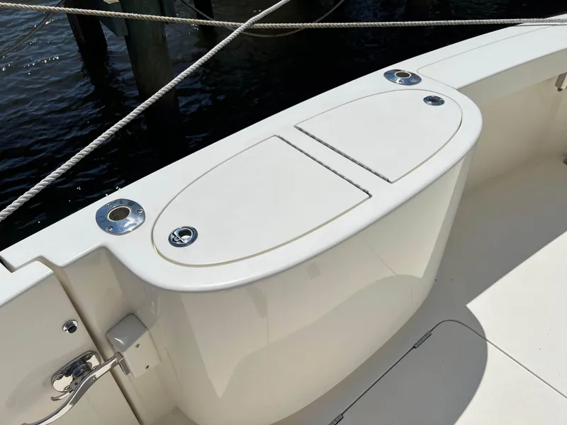 Slide: The Image of 2022 Henriques 42 Express Hardtop boat deck with storage compartments and fishing rod holders. - 24