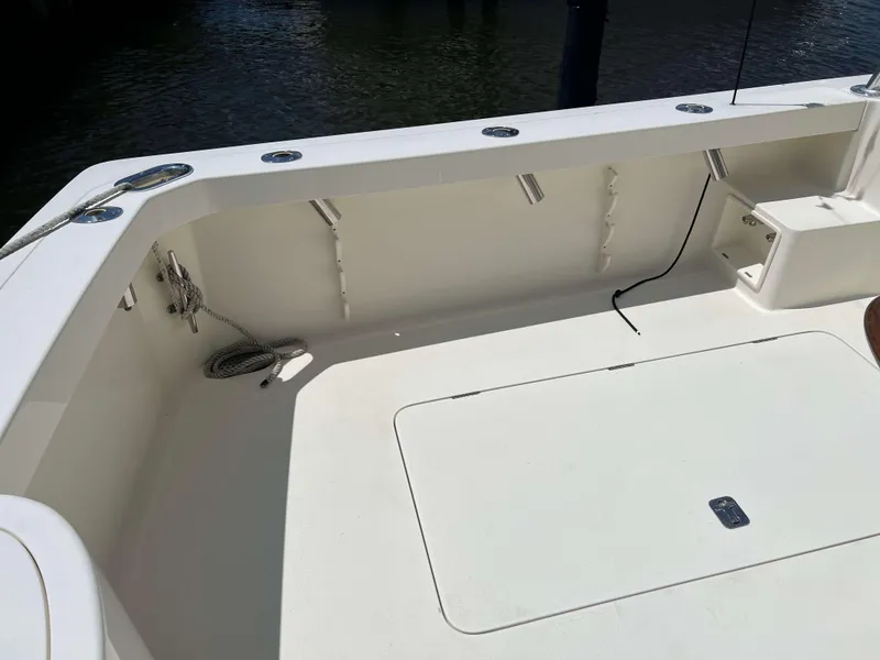 Slide: The Image of 2022 Henriques 42 Express Hardtop boat deck with storage hatch and fishing rod holders. - 33