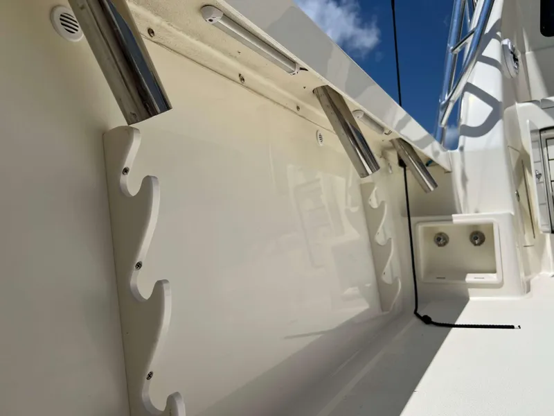 Slide: The Image of 2022 Henriques 42 Express Hardtop boat interior with rod holders and storage compartments. - 34