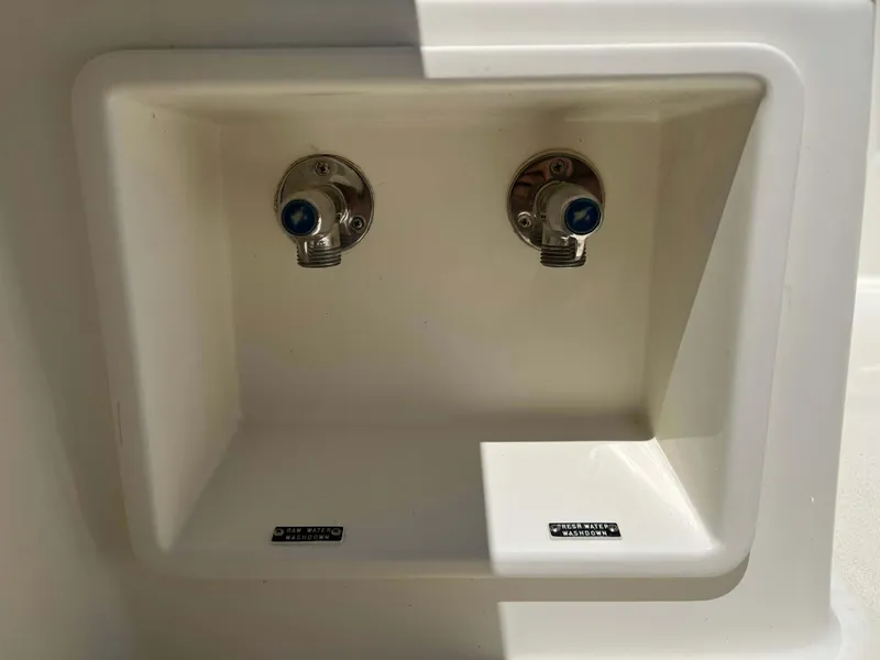 Slide: The Image of Water connections on a 2022 Henriques 42 Express Hardtop boat, labeled for raw and fresh water. - 35