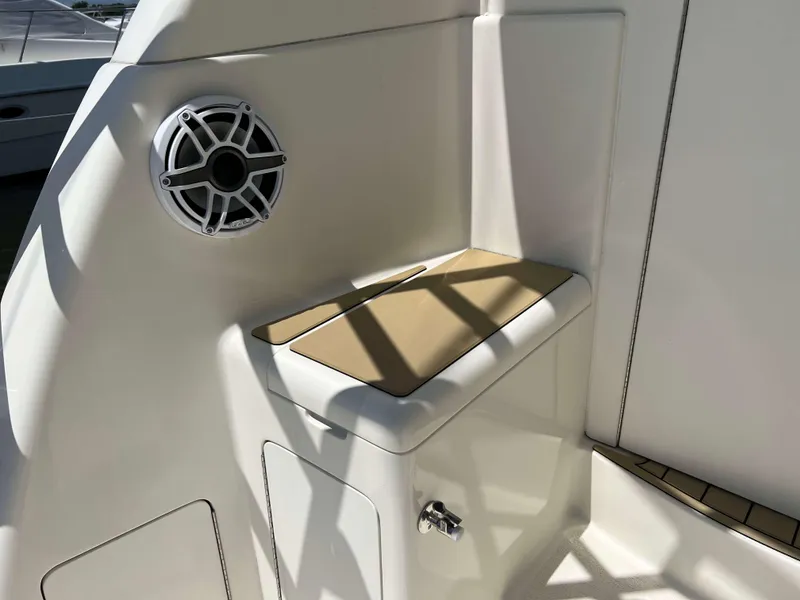 Slide: The Image of 2022 Henriques 42 Express Hardtop boat interior with speaker and cushioned seat. - 36