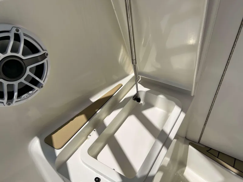 Slide: The Image of 2022 Henriques 42 Express Hardtop interior detail with speaker and storage compartment. - 37