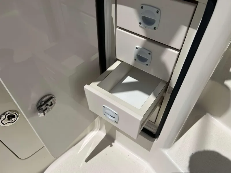 Slide: The Image of Open storage drawers on a 2022 Henriques 42 Express Hardtop boat. - 39