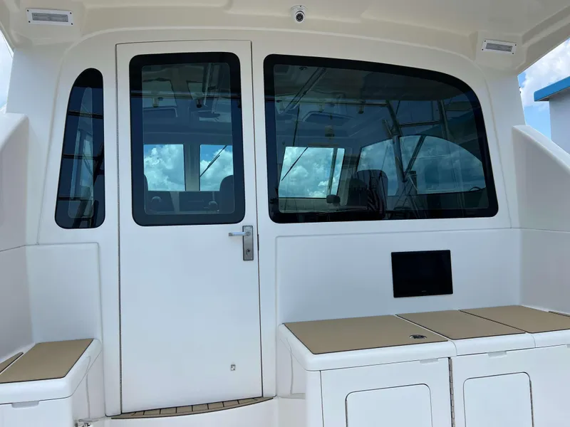 Slide: The Image of 2022 Henriques 42 Express Hardtop boat interior with seating and glass door. - 41