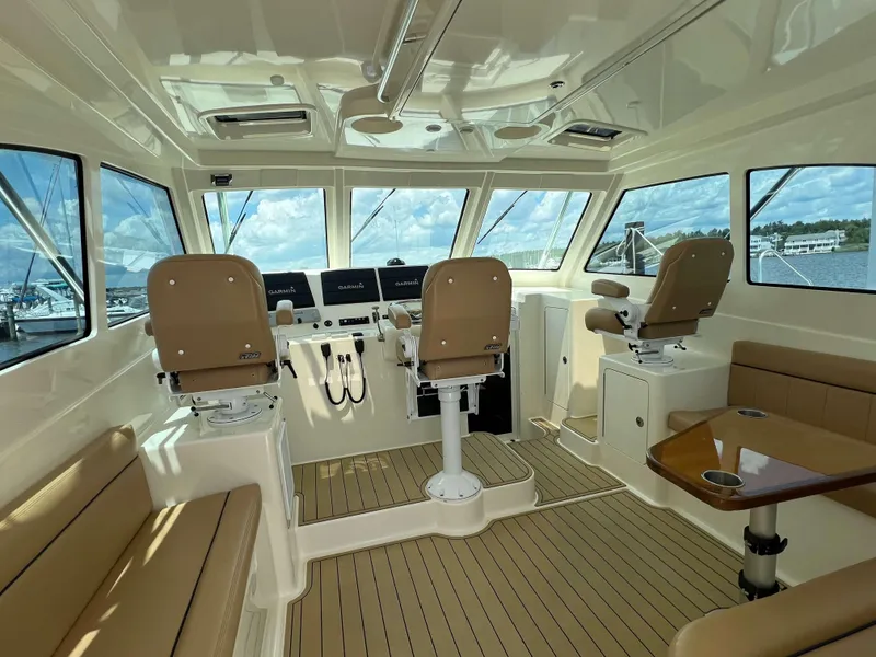 Slide: The Image of Interior of 2022 Henriques 42 Express Hardtop boat with seating and navigation equipment. - 43