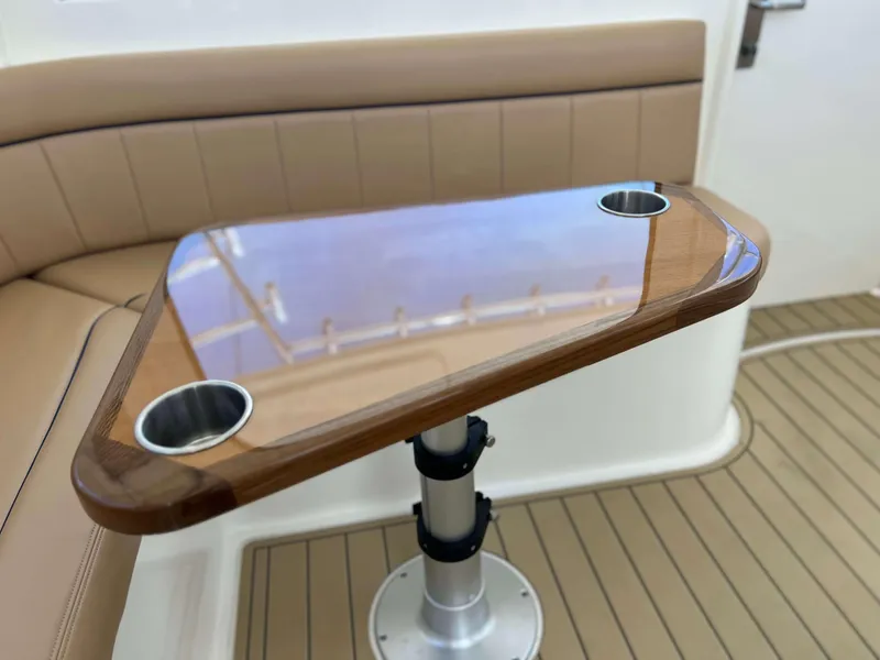Slide: The Image of Henriques 42 Express Hardtop 2022 interior with wooden table and cup holders. - 48