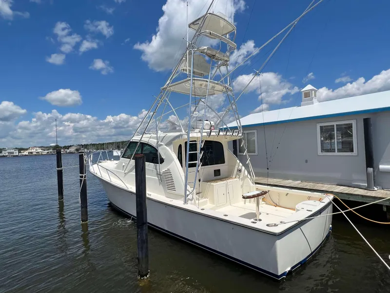 Slide: The Image of 2022 Henriques 42 Express Hardtop boat docked under a clear blue sky. - 5