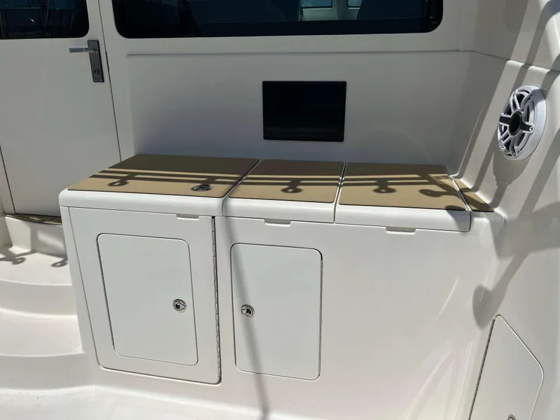 Slide: The Image of 2022 Henriques 42 Express Hardtop interior with storage compartments and speaker. - 8