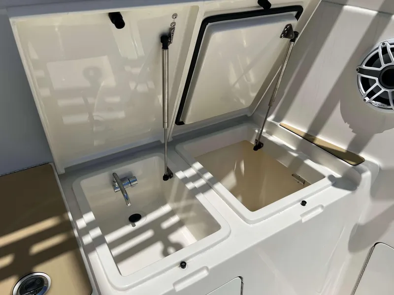 Slide: The Image of 2022 Henriques 42 Express Hardtop boat sink and storage compartments. - 9