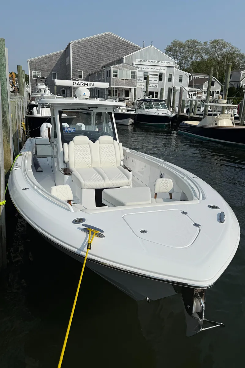 Slide: The Image of 2025 Everglades 375 Center Console boat docked at a marina, featuring sleek design and modern amenities. - 13