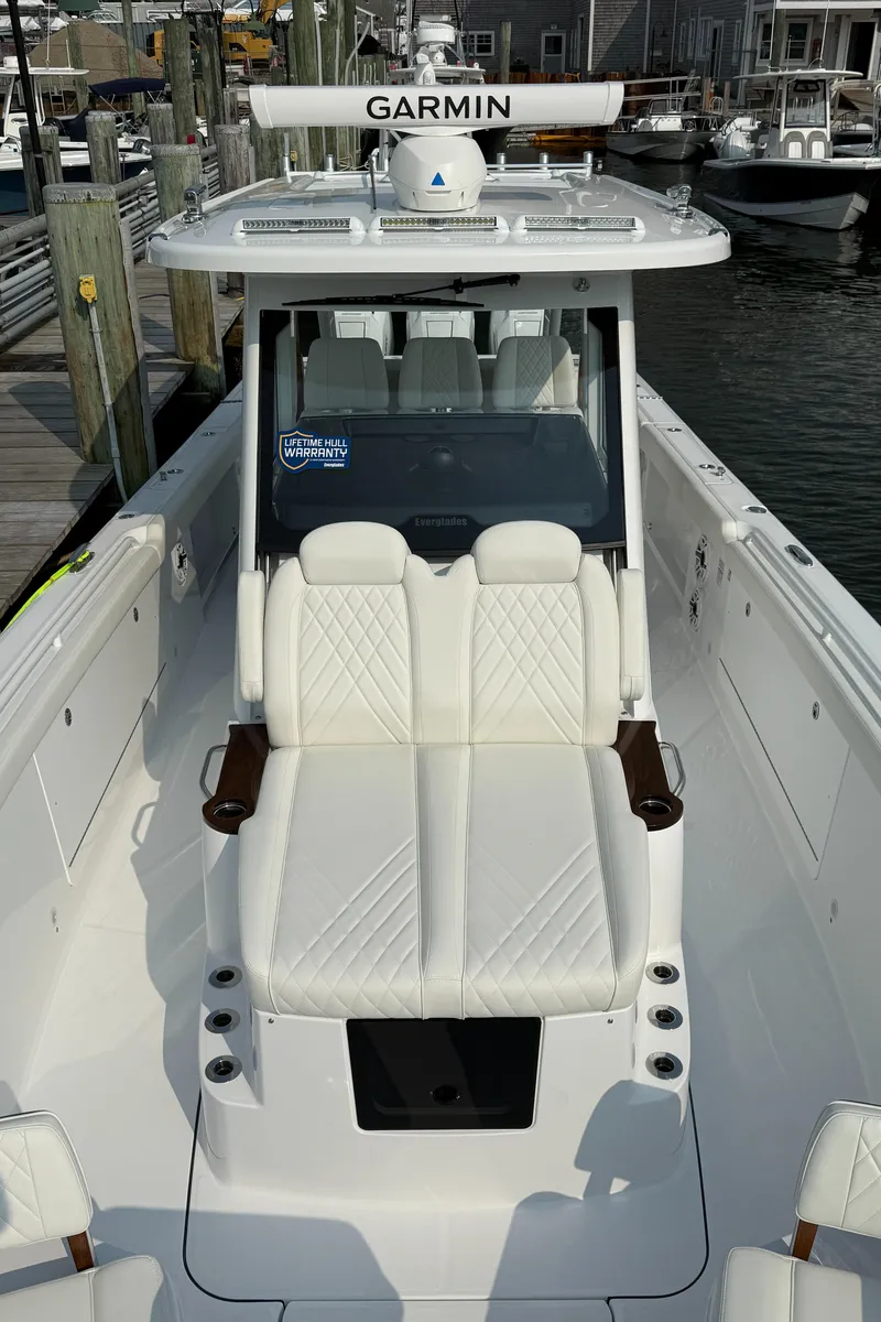 Slide: The Image of 2025 Everglades 375 Center Console boat with white seating and Garmin equipment. - 15