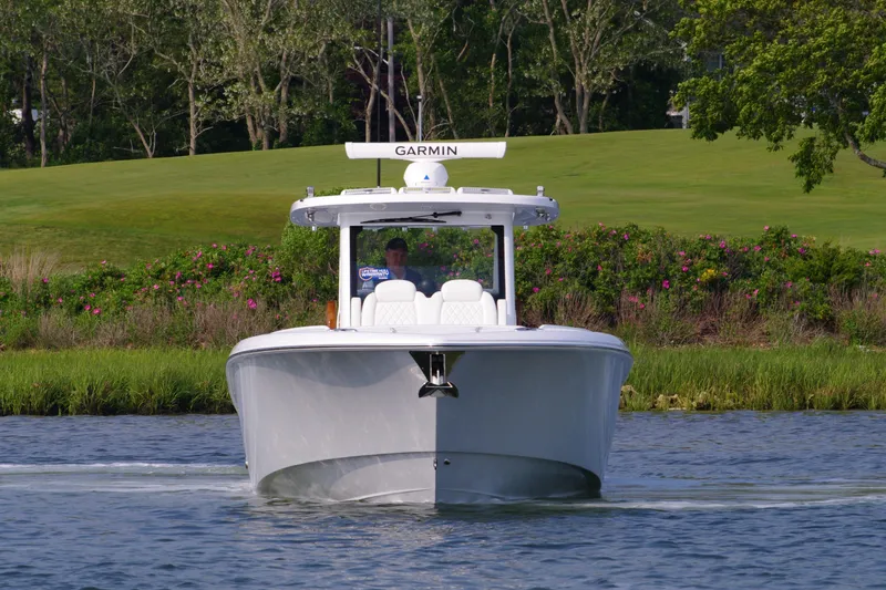 Slide: The Image of 2025 Everglades 375 Center Console boat cruising on a scenic waterway. - 3