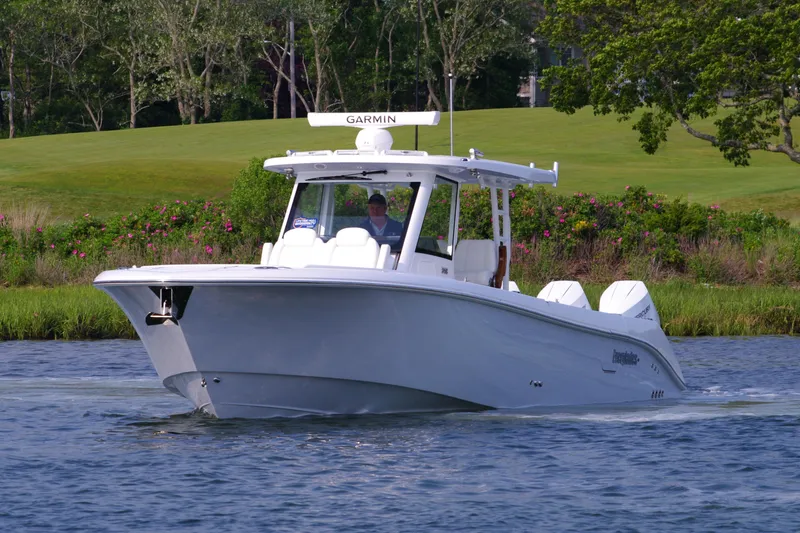 Slide: The Image of 2025 Everglades 375 Center Console boat cruising on a scenic waterway. - 4