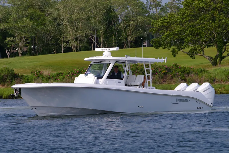 Slide: The Image of 2025 Everglades 375 Center Console boat cruising on a scenic waterway. - 6