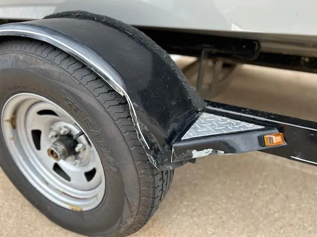 Slide: The Image of Damaged trailer fender on 2014 Bass Tracker PRO GUIDE V 175 SC boat. - 14