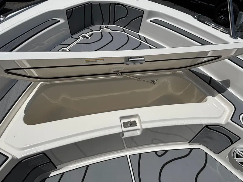 Slide: The Image of 2023 Boston Whaler 220 Dauntless boat storage compartment open, showcasing spacious interior. - 12