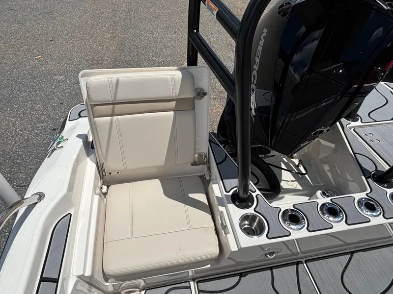 Slide: The Image of 2023 Boston Whaler 220 Dauntless boat seat and Mercury engine detail. - 13