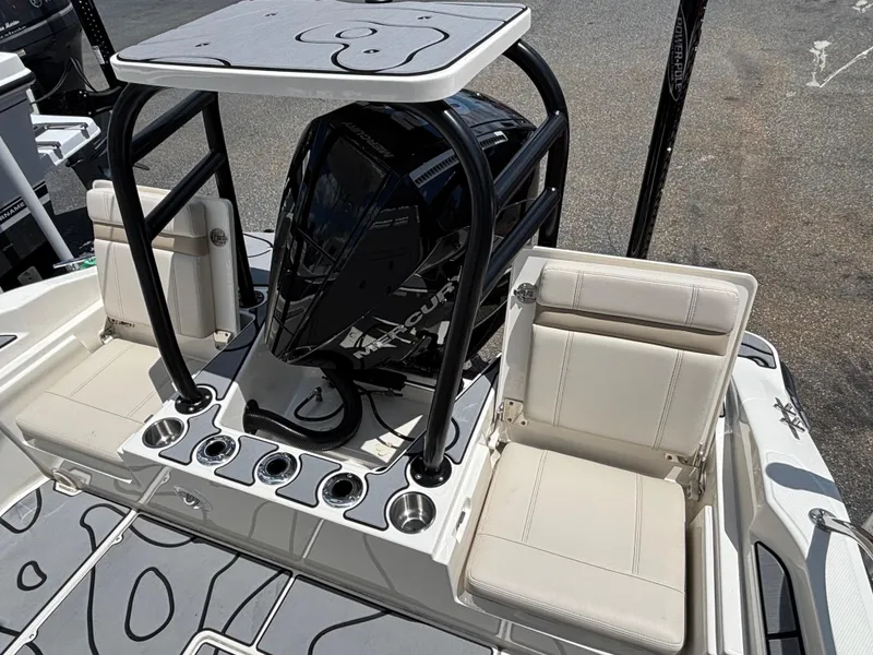 Slide: The Image of 2023 Boston Whaler 220 Dauntless boat interior with seating and Mercury engine. - 14