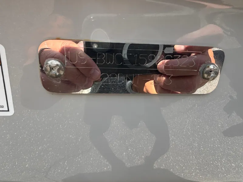 Slide: The Image of 2023 Boston Whaler 220 Dauntless hull identification number plate with reflection. - 23