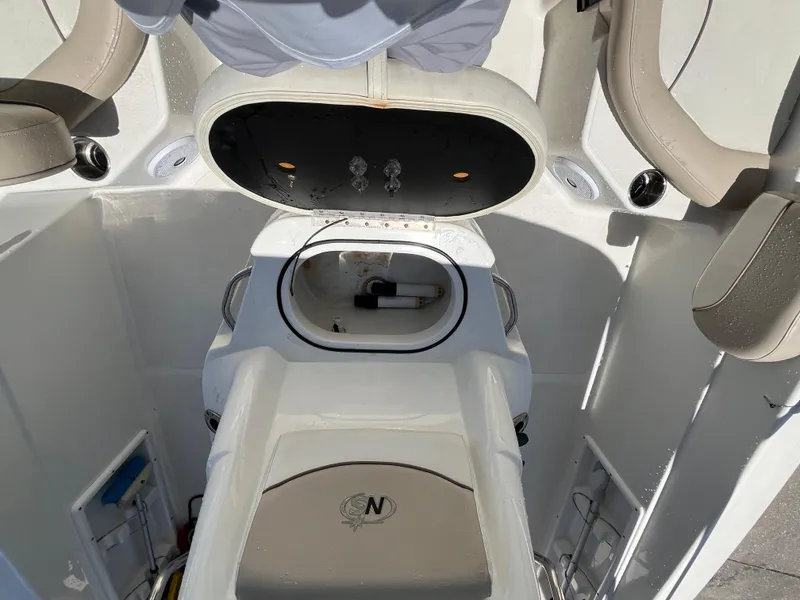 Slide: The Image of 2016 NauticStar 211 Angler boat interior with seating and storage compartments. - 6