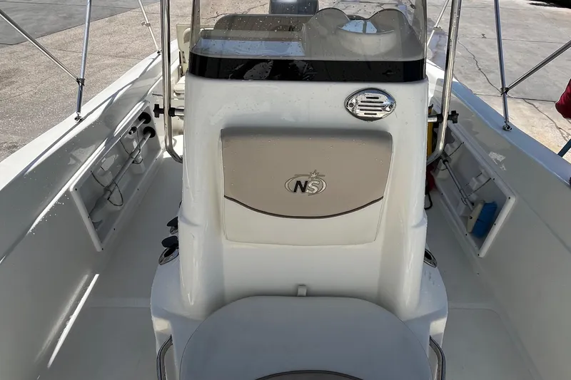 Slide: The Image of 2016 NauticStar 211 Angler boat interior with console and seating. - 8