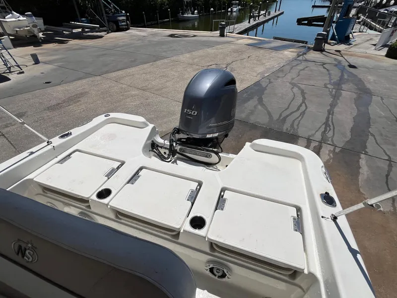 Slide: The Image of 2016 NauticStar 211 Angler boat with Yamaha 150 outboard motor at dockside. - 9