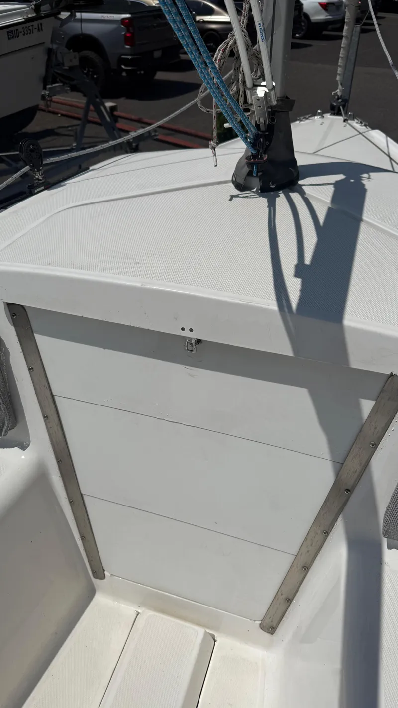 Slide: The Image of 2011 Marlow-Hunter 22 sailboat deck with rigging and shadow details. - 11