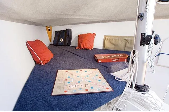 Slide: The Image of Cozy cabin interior of 2011 Marlow-Hunter 22 sailboat with Scrabble game setup. - 15