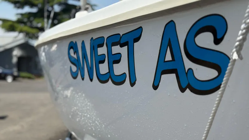 Slide: The Image of Marlow-Hunter 22 sailboat with "Sweet As" text on hull, 2011 model. - 2