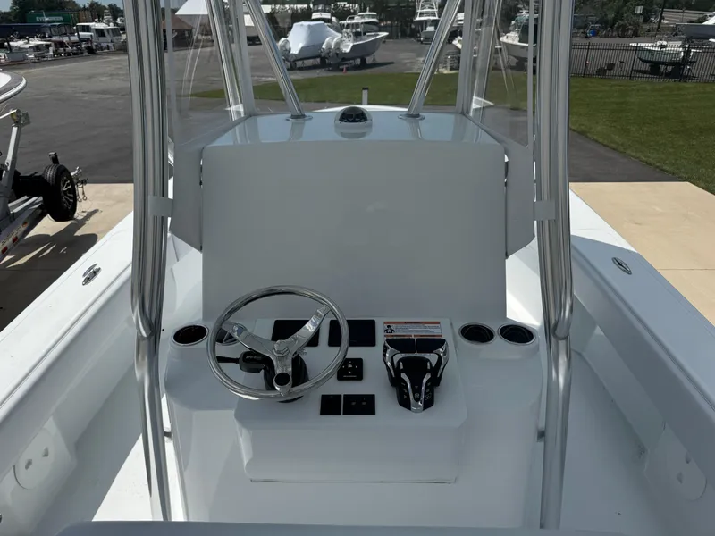 Slide: The Image of 2025 Contender 29 Bay boat console with steering wheel and controls. - 3