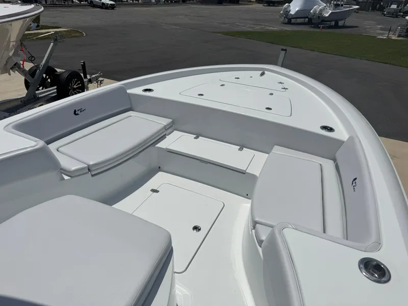 Slide: The Image of 2025 Contender 29 Bay boat interior with white seating and storage compartments. - 6