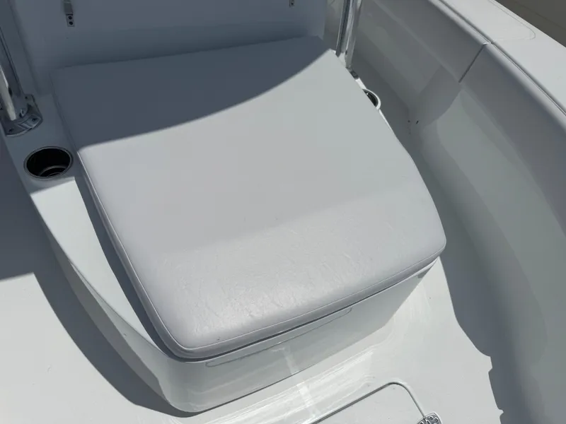 Slide: The Image of 2025 Contender 29 Bay boat seat with cup holders, white upholstery. - 7