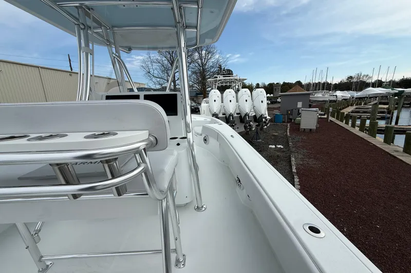 Slide: The Image of 2025 Contender 29 Bay boat with sleek design and powerful engines at a marina. - 9