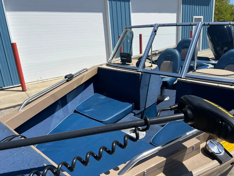 Slide: The Image of 1998 Lund 1700 Pro Sport Adventure boat interior with blue seating and steering controls. - 12