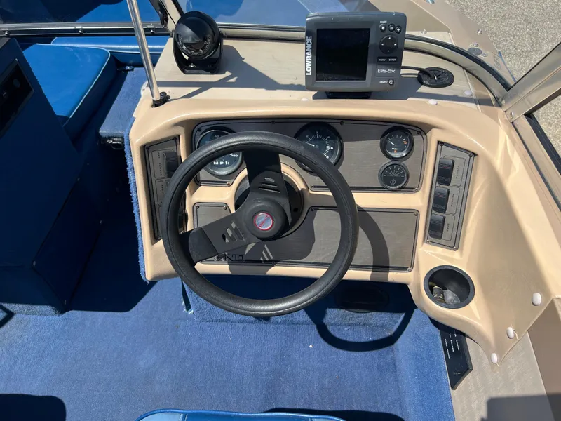 Slide: The Image of 1998 Lund 1700 Pro Sport Adventure boat dashboard with steering wheel and navigation equipment. - 14