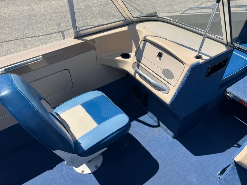 Slide: The Image of Interior of a 1998 Lund 1700 Pro Sport Adventure boat with blue seating and dashboard. - 15