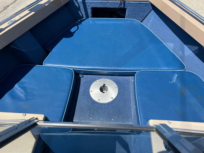 Slide: The Image of 1998 Lund 1700 Pro Sport Adventure boat interior with blue seating and metal fixture. - 16