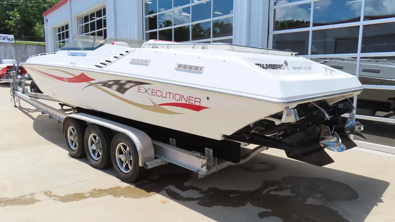 Slide: The Image of 2004 Fountain 35 Executioner speedboat on a trailer, parked outside a building. - 10