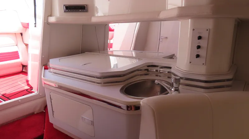 Slide: The Image of Interior of 2004 Fountain 35 Executioner boat with kitchenette and seating area. - 17